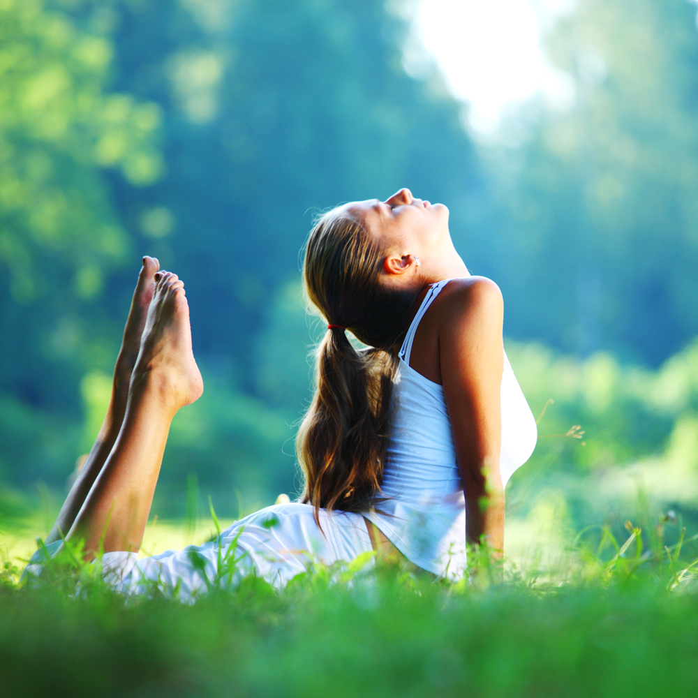 yoga-woman-park-shutterstock_88490455